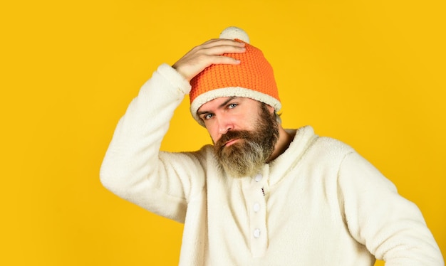 Ready for holiday Handsome male model wearing warm hat casual man in winter hat and warm clothes happy hipster wear warm hat cold and flu Portrait of brutal man in fleece sweatshirt