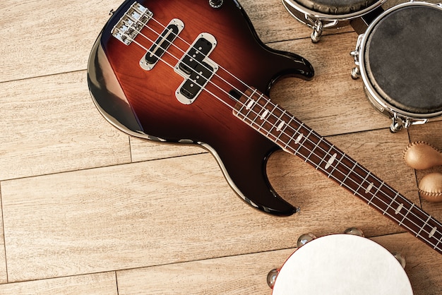 Ready for performance top view of musical instruments set brown electric guitar drums gold maracas