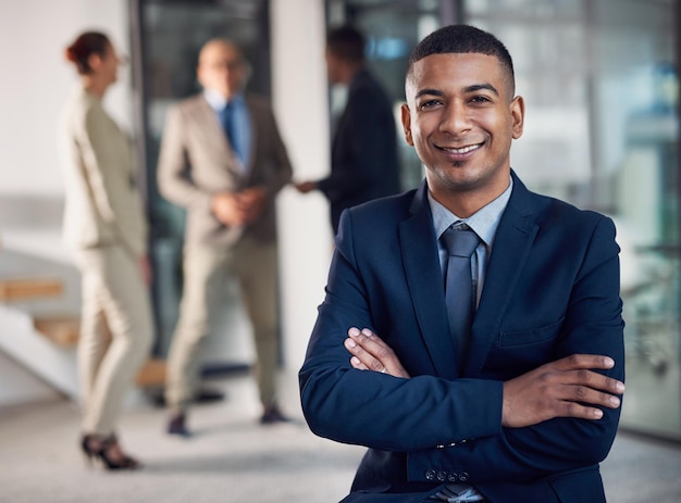 Ready for success Portrait of a corporate businessman standing in an office