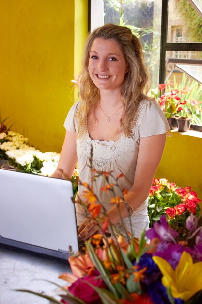 Ready to take your order Shot of a young florist at work in a flower shop