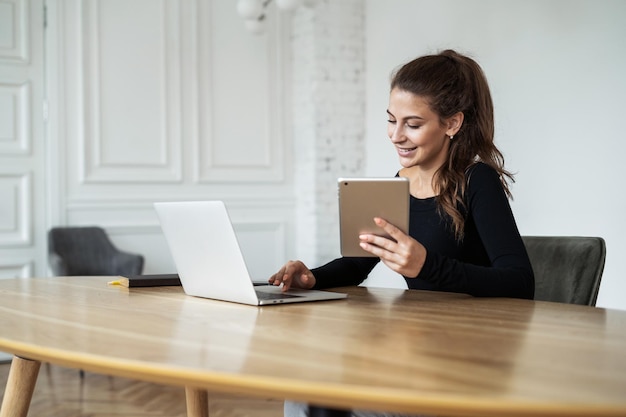 Reageert op klanten via e-mail Een vrouw zit thuis op kantoor Werken op een computer op afstand