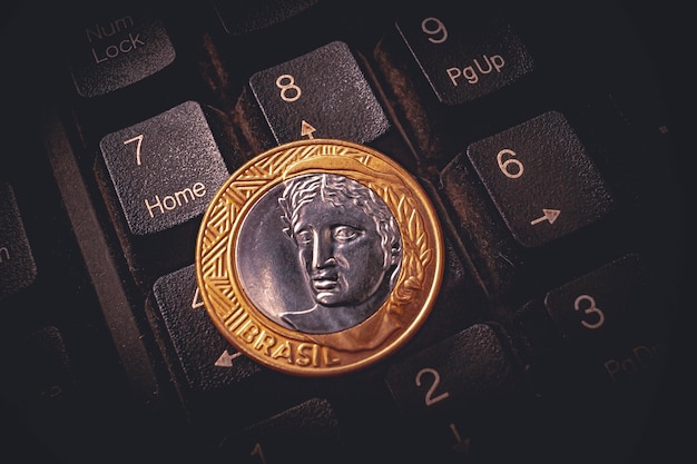 a real 1 coin on a computer keyboard