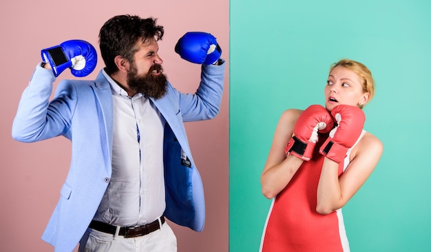 Photo real champion bearded man hipster fighting with woman family couple boxing gloves strength and power problems in relationship sport knockout punching who is right win the fight