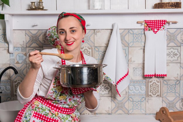 A real cute housewife cooks in the kitchen