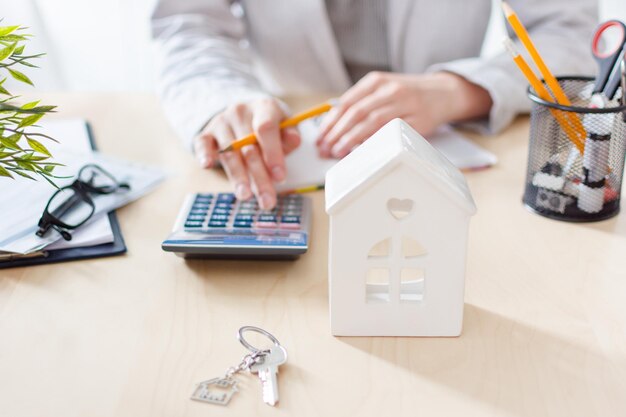 Real estate agent calculating taxes and profits to invest in home buying Real estate market