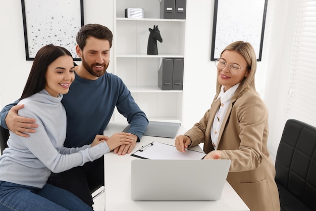 Real estate agent consulting couple in office