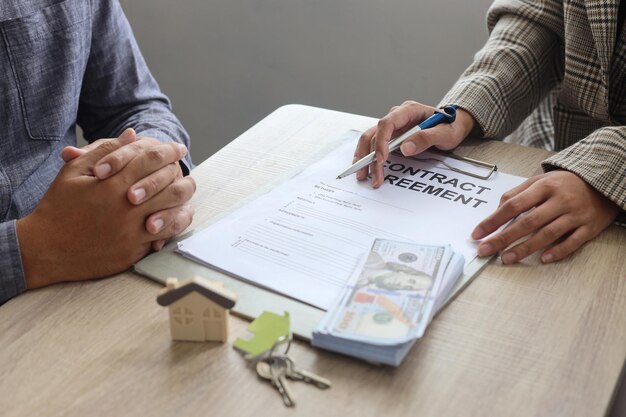 Photo real estate agent and customer signing contract to buy house, insurance or loan real estate.