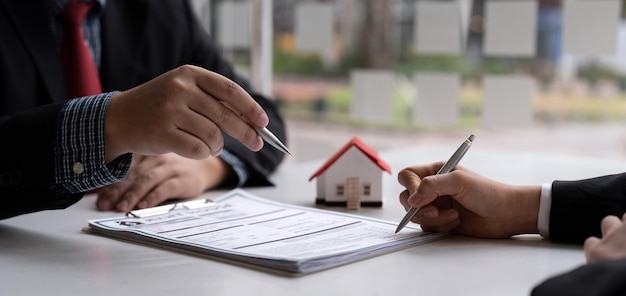 Real estate agent and customer signing contract to buy house insurance or loan real estaterent a houseget insurance or loan real estate or property