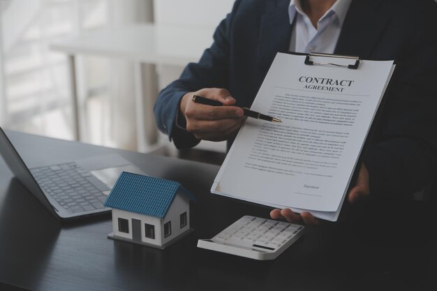 Real estate agent and customer signing contract to buy house insurance or loan real estaterent a houseget insurance or loan real estate or property