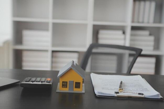 real estate agent and customer signing contract to buy house insurance or loan real estaterent a houseget insurance or loan real estate or property