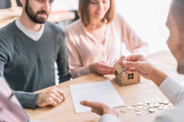 Photo real estate agent giving clients keys