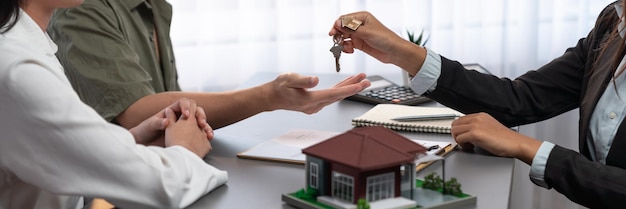 Real estate agent hand over house key to buyer Prodigy