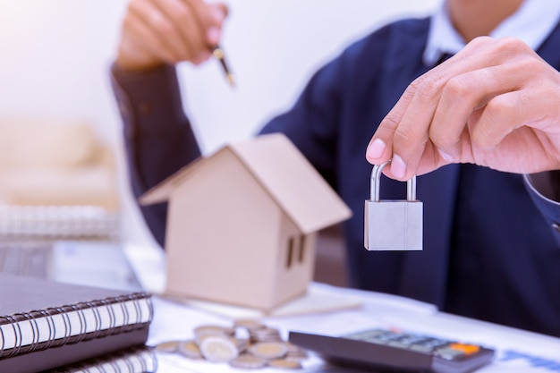 Real estate agent handing over a house key.