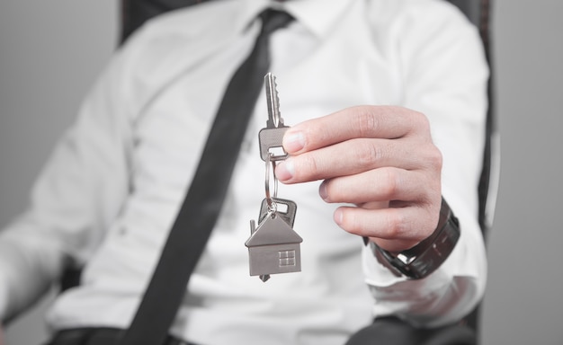 Real estate agent holding house keys.