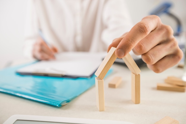 A real estate agent holds in his hand part of the layout of the house. 