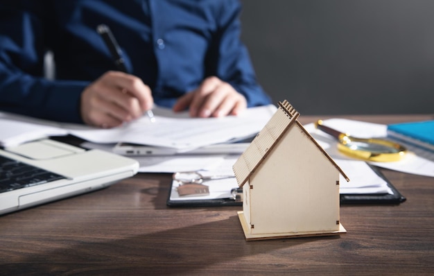 Real estate agent signing document for home loan insurance.