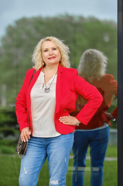 Real estate agent stands near the reinforced glass wall of the building