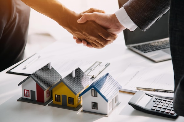 Real estate agent talked about the terms of the home purchase agreement and asked the customer to sign the documents to make the contract legally Home sales and home insurance concept