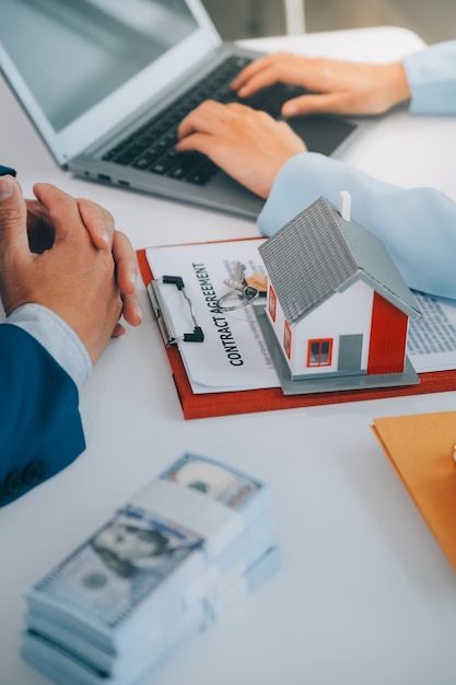 Real estate agent talked about the terms of the home purchase agreement and asked the customer to sign the documents to make the contract legally Home sales and home insurance concept