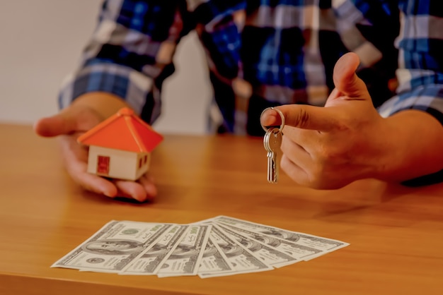 Real estate agent with house model and keys