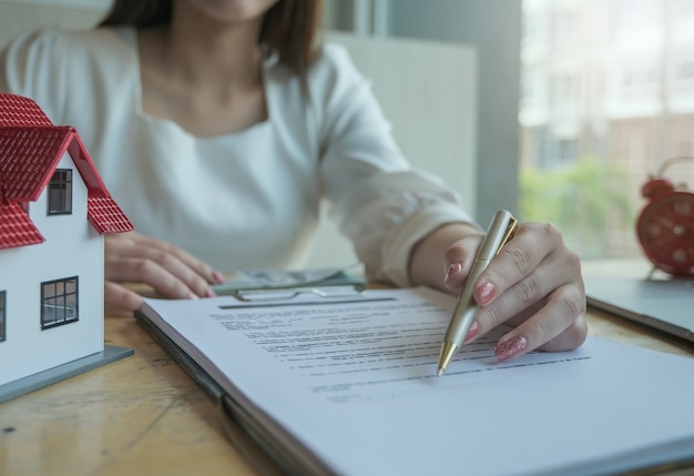 Real estate agents discussing about loans and interest rates for buying houses for customers who come to contact. contract and agreement concepts.