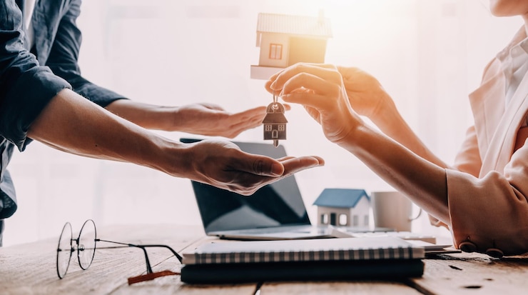 Photo real estate broker agent presenting and consult to customer to decision making sign insurance form agreement buy and sell home model concerning mortgage loan offer for and house insurance