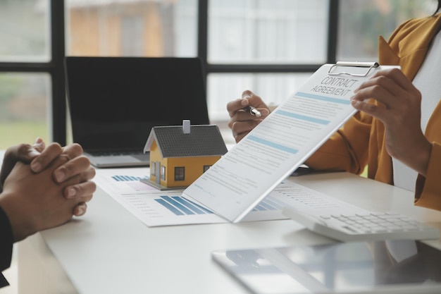 real estate brokerage agent deliver a sample of a model house to the customer mortgage loan agreement making lease and buy and sell house and contract home insurance mortgage loan concept