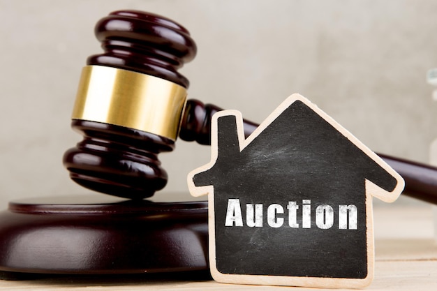 Real estate concept auction gavel and little house with inscription Auction