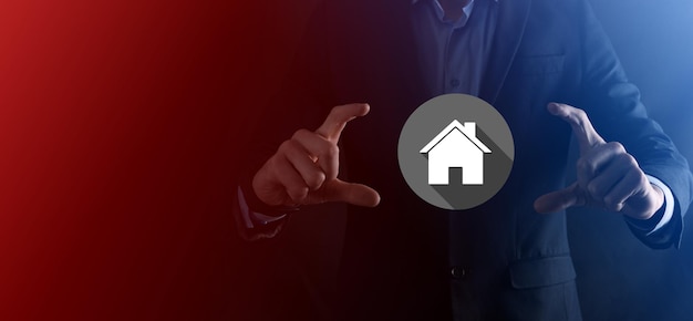 Real estate concept, businessman holding a house icon.House on Hand.Property insurance and security concept. Protecting gesture of man and symbol of house.flat icons with long shadows.