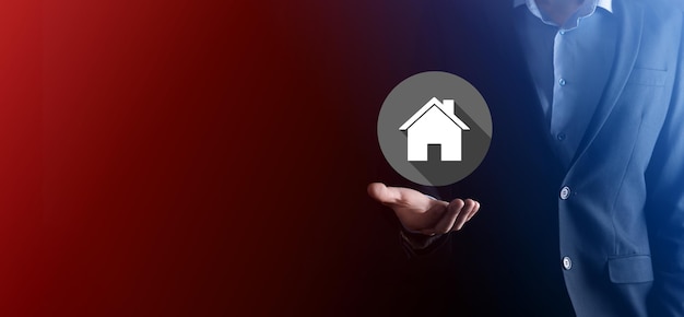 Real estate concept, businessman holding a house icon.House on Hand.Property insurance and security concept. Protecting gesture of man and symbol of house.flat icons with long shadows.