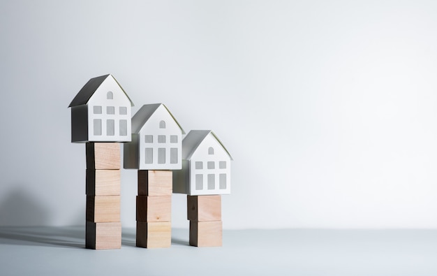 Real estate concepts with model house on wood box