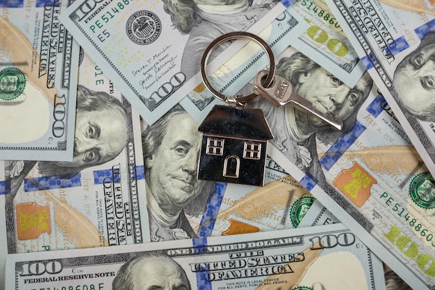 Real estate fraud concept The keychain and the key to the house lie on the money