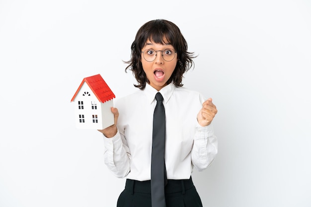 Real estate mixed race agent isolated on white background celebrating a victory in winner position