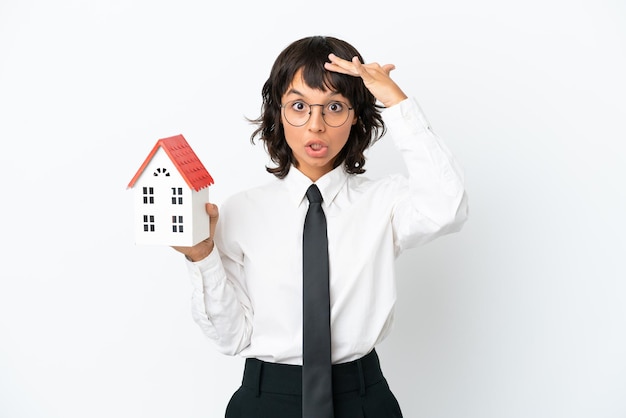 Real estate mixed race agent isolated on white background doing surprise gesture while looking to the side