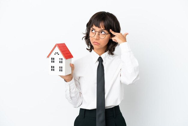 Real estate mixed race agent isolated on white background having doubts and thinking