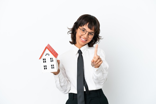 Real estate mixed race agent isolated on white background showing and lifting a finger