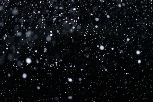 Photo real falling snow on black background for blending modes in ps. ver 01 - many snowflakes in blur.