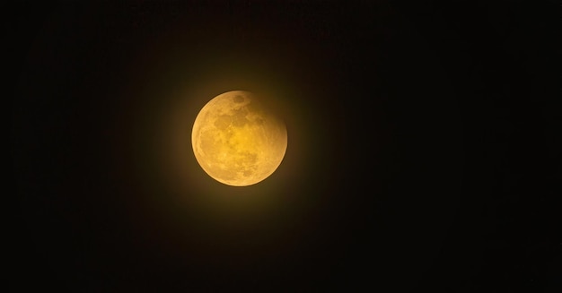 Real full blood moon half moon in black sky with cloud