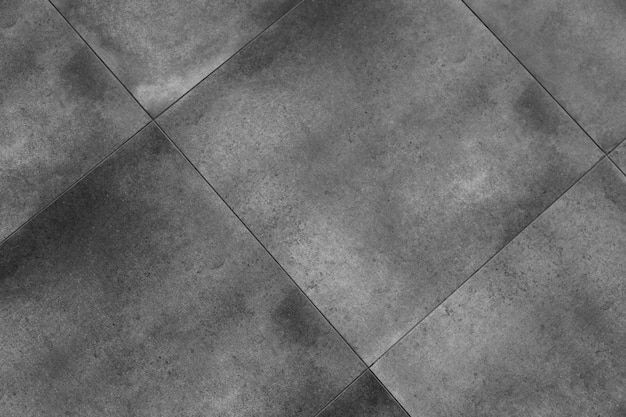 背景の実際の灰色の床タイルパターン。灰色の色合いの屋外舗装