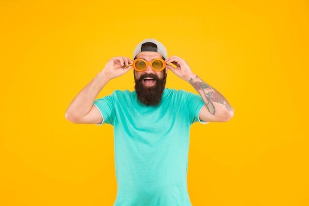 Real happiness. bearded guy in party glasses. just like a freak. he is going crazy. summer male fashion. happy and smiling hipster. fun and entertainment. casual hipster outfit. funny man having fun