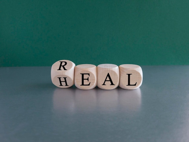 Real heal symbol Fliped a wooden cube with words 039Real heal039 Beautiful green background