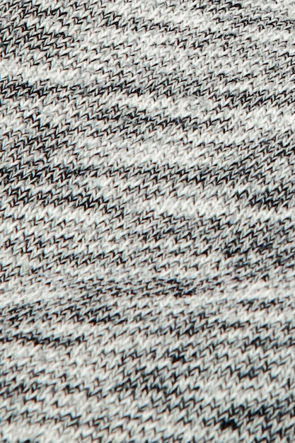 Real heather grey knitted fabric made of synthetic fibres textured background.