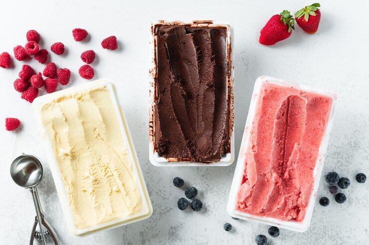 Real Italian artisanal ice cream in packing box chocolate strawberries vanilla with berries and a spoon