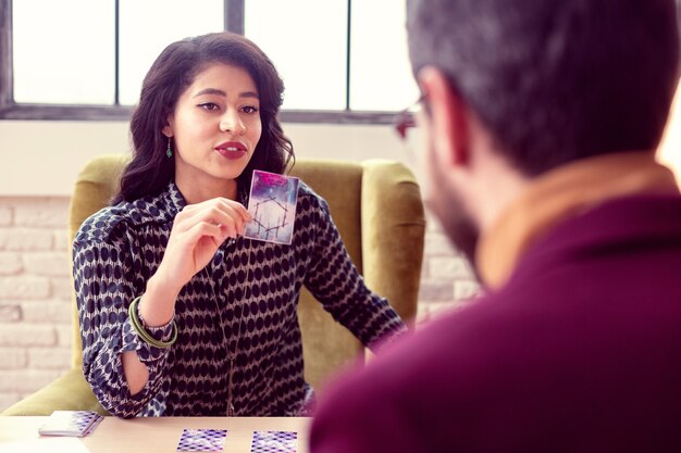 Real magic. Delighted pleasant woman smiling while looking at her client