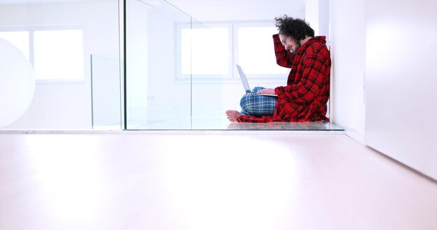 Real man Using laptop on the floor At Home  Enjoying Relaxing