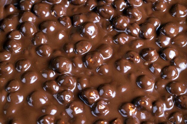 Real milk chocolate while cooking with hazelnuts