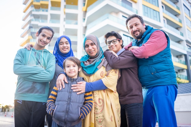 Real muslim family on city street together