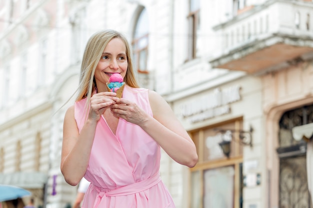 Real portrait woman happy blonde middle age nature summer long hair sunlight fifty plus 50 pink ice cream