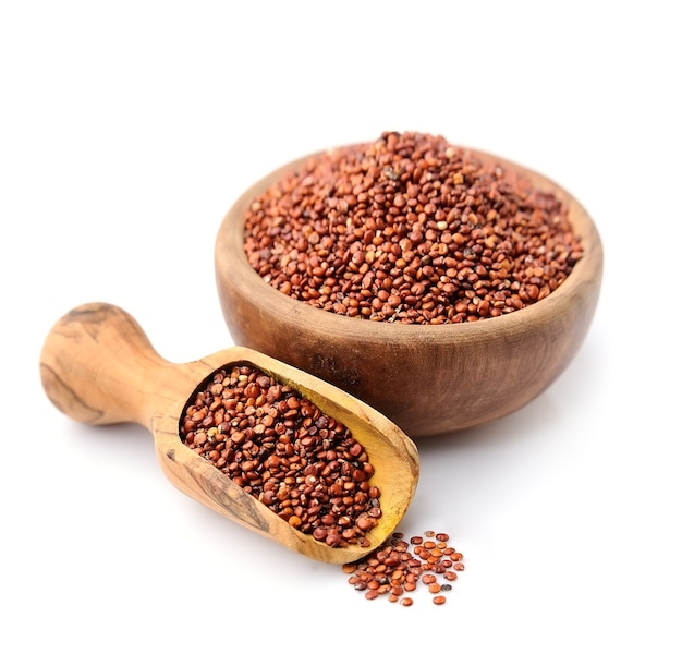 Real quinoa in a wooden bowl isolated on white