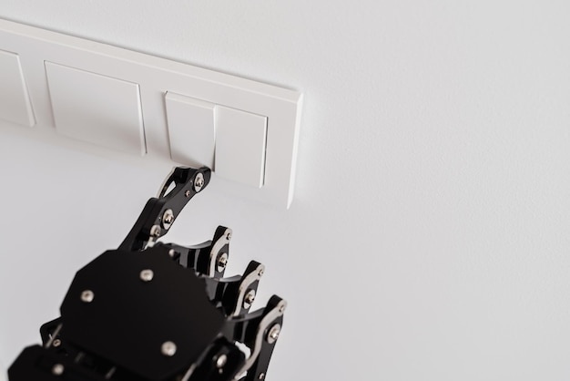 Photo real robot's hand pressing button on a light switch concept of robotic process automation